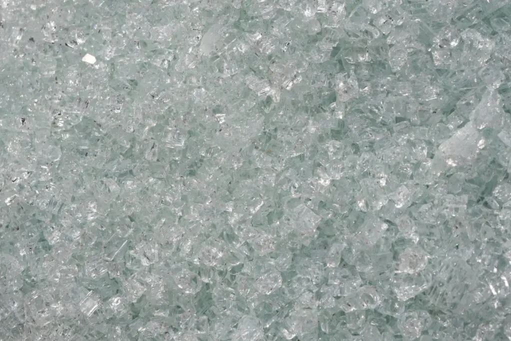 Close-up of broken glass pieces, symbolizing recycling and sustainability.